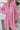 Person wearing a pink leopard print dress with a white background