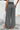 Person wearing black and white patterned wide-leg pants, back view