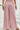 Person wearing pink floral wide-leg pants, back view