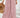 Person wearing pink floral wide-leg pants with a white background