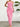 Pink strapless ruffled dress worn by a person against a white wall with a plant in the background