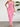 Pink strapless ruffled dress worn by a person against a white wall with a plant in the corner