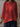 Red long-sleeve top worn by a person against a neutral background