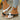 White and black sandals with brown soles, side view
