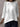 White blouse worn by a person against a neutral background