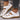White sandals with brown soles for women, side view