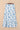 White skirt with blue floral pattern on a beige background
