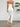 White strapless dress with a high slit worn by a person, standing against a plain background