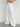 White wide-leg pants worn by a person on a plain background