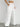 White wide-leg pants worn by a women on a plain background