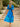 Woman in a blue floral dress, back view