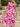 Woman in a pink floral dress standing outdoors on stone steps