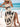 Woman in a white boho dress with black patterns sitting on a beach