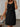 Woman wearing a black dress with a neutral background