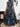 Woman wearing a blue and black dress, back view