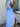 Woman wearing a blue and white striped dress with a slit