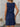 Woman wearing a blue dress with a white background
