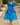 Woman wearing a blue floral dress, front view