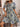 Woman wearing a floral dress in an indoor setting