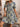 Woman wearing a floral dress with a neutral background