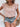 Woman wearing a floral top and denim shorts with a neutral background