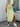 Woman wearing a green and white striped dress, back view