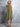 Woman wearing a green dress against a gray background