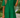 Woman wearing a green dress with a blurred natural background
