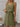 Woman wearing a green sleeveless dress with a white background