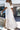 Woman wearing a white lace dress by a poolside