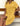 Woman wearing a yellow dress with buttons sitting on a wooden bench