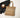 Woven tote bag with leather handles on a white surface with a black jacket and ceramic cup