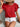 Person wearing a red ruffled top and white shorts against a neutral background