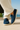 navy suede loafers for men with cream sole, styled with white linen pants on a sunlit coastal terrace — smart casual shoes for effortless Australian style.
